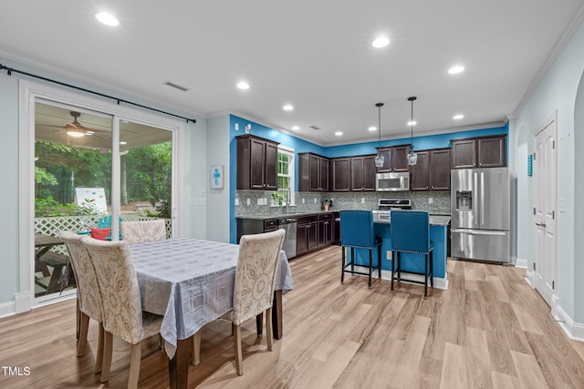 1939 Mostyn Ln, Apex, NC 27502 - dining area with ornamental molding, light wood finished floors, baseboards, recessed lighting, and ceiling fan