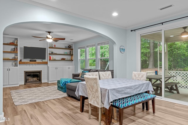 1939 Mostyn Ln, Apex, NC 27502 - dining room featuring a ceiling fan, ornamental molding, light wood finished floors, arched walkways, and recessed lighting