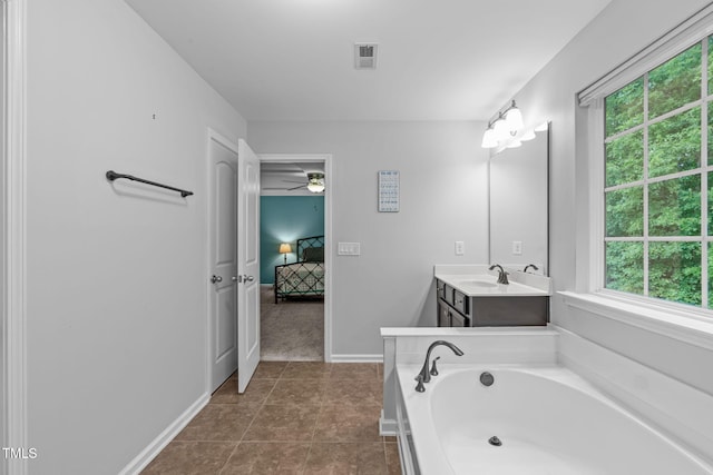 1939 Mostyn Ln, Apex, NC 27502 - ensuite bathroom featuring vanity, a garden tub, healthy amount of natural light, and a ceiling fan
