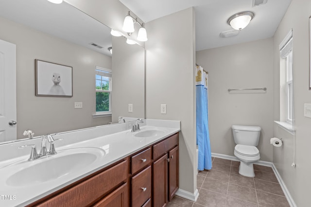 1939 Mostyn Ln, Apex, NC 27502 - bathroom featuring toilet, double vanity, tile patterned flooring, baseboards, and curtained shower