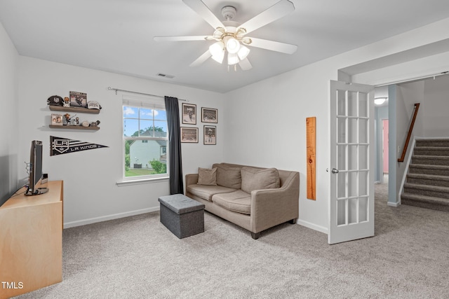 1939 Mostyn Ln, Apex, NC 27502 - carpeted living area with ceiling fan, stairway, and baseboards
