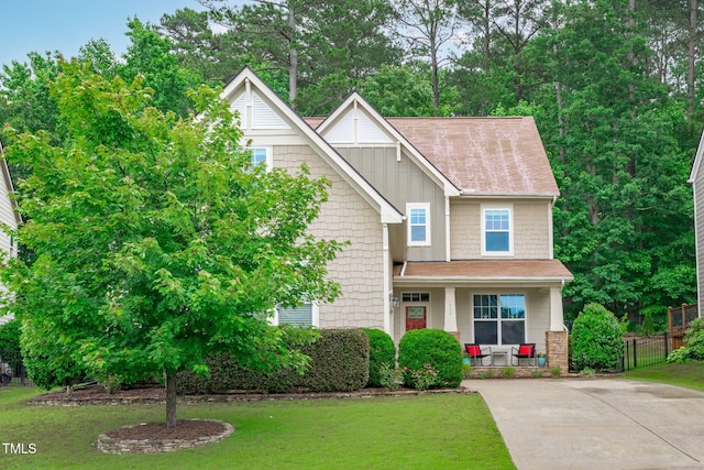 1939 Mostyn Ln, Apex, NC 27502 - view of front of home with covered porch, board and batten siding, a shingled roof, and concrete driveway