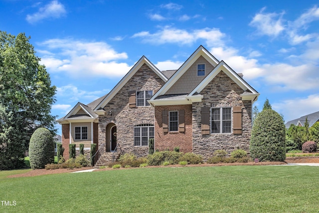 105 Somerley Dr, Garner, NC 27529 - craftsman inspired home featuring stone siding, a front lawn, and brick siding