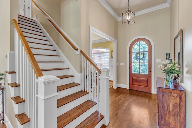 105 Somerley Dr, Garner, NC 27529 - foyer with ornamental molding, wood finished floors, stairs, a chandelier, and a towering ceiling