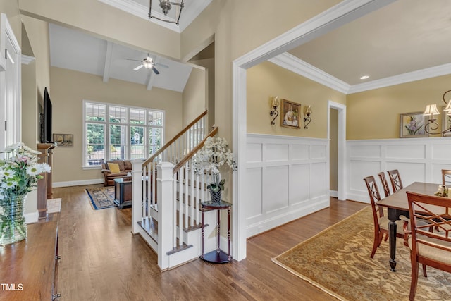 105 Somerley Dr, Garner, NC 27529 - foyer entrance featuring ornamental molding, wood finished floors, stairway, a decorative wall, and a ceiling fan
