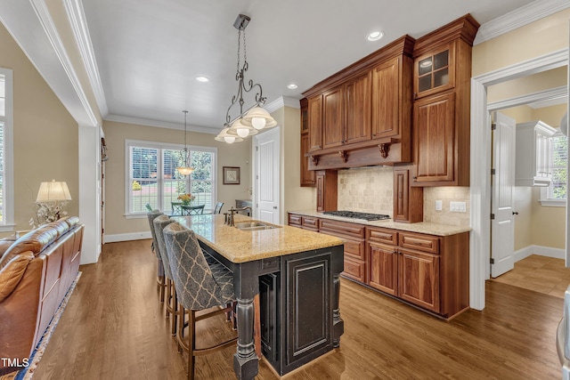 105 Somerley Dr, Garner, NC 27529 - kitchen with stainless steel gas cooktop, baseboards, wood finished floors, light stone counters, and healthy amount of natural light