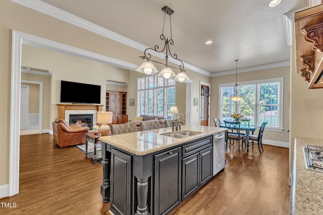 105 Somerley Dr, Garner, NC 27529 - kitchen with a sink, stainless steel appliances, wood finished floors, crown molding, and baseboards