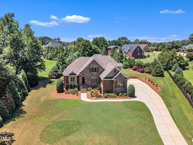 105 Somerley Dr, Garner, NC 27529 - view of front of house with stone siding, concrete driveway, and a front yard