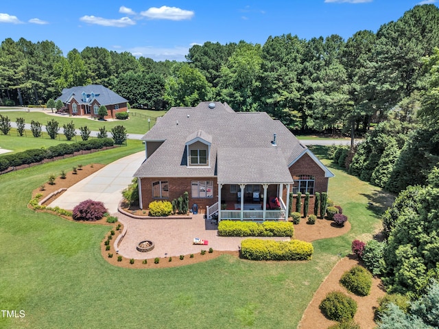 105 Somerley Dr, Garner, NC 27529 - view of front facade with a porch, brick siding, a front lawn, and roof with shingles