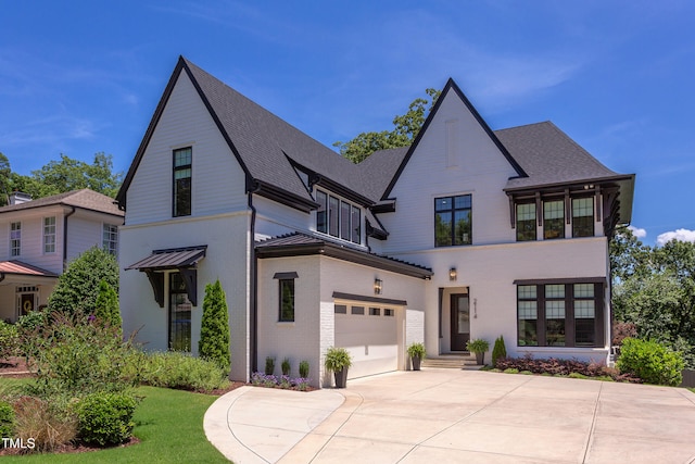 2114 Cowper Dr, Raleigh, NC 27608 - view of front of property featuring driveway, brick siding, and roof with shingles