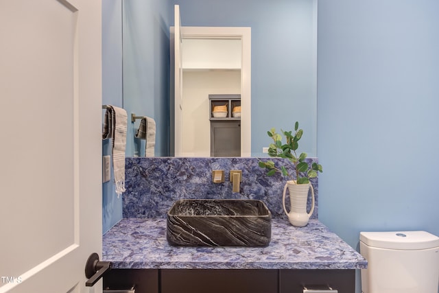 2114 Cowper Dr, Raleigh, NC 27608 - half bathroom with vanity and tasteful backsplash