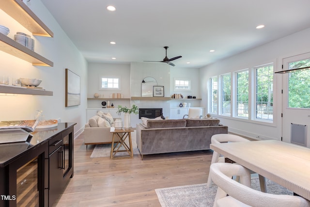 2114 Cowper Dr, Raleigh, NC 27608 - living room featuring wine cooler, recessed lighting, a ceiling fan, light wood finished floors, and a fireplace