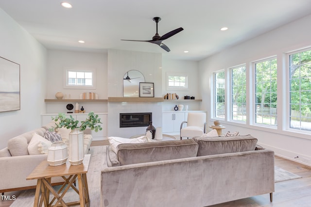 2114 Cowper Dr, Raleigh, NC 27608 - living room with healthy amount of natural light, ceiling fan, recessed lighting, wood finished floors, and a large fireplace