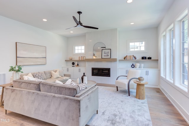 2114 Cowper Dr, Raleigh, NC 27608 - living room with ceiling fan, a large fireplace, wood finished floors, and recessed lighting