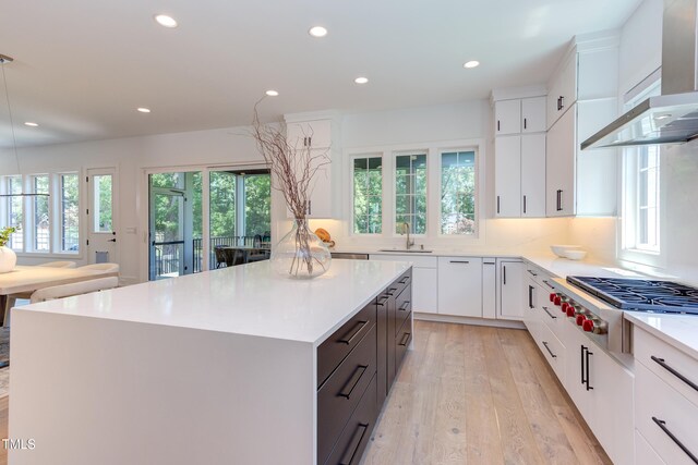2114 Cowper Dr, Raleigh, NC 27608 - kitchen featuring premium range hood, stainless steel gas stovetop, plenty of natural light, recessed lighting, and a kitchen island
