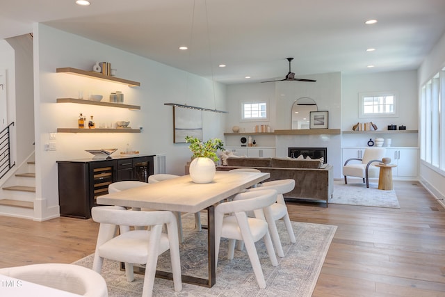 2114 Cowper Dr, Raleigh, NC 27608 - dining area featuring bar with sink, a ceiling fan, recessed lighting, a fireplace, and light wood-style flooring