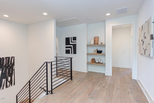 2114 Cowper Dr, Raleigh, NC 27608 - hall with an upstairs landing, attic access, wood finished floors, and recessed lighting
