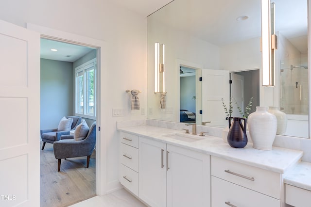 2114 Cowper Dr, Raleigh, NC 27608 - bathroom featuring ensuite bath, vanity, a tile shower, and wood finished floors