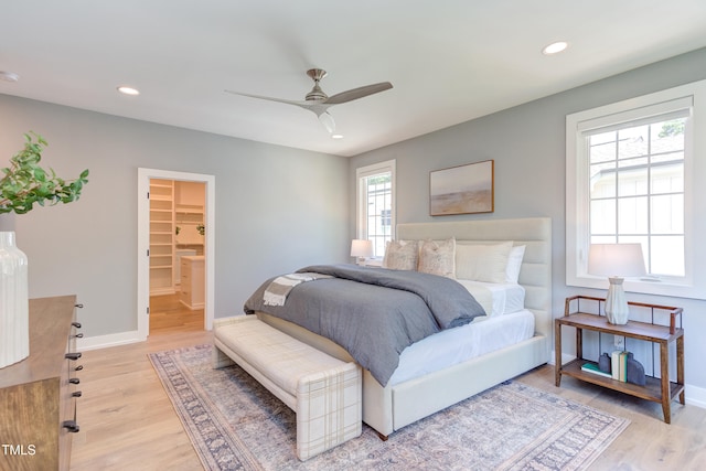 2114 Cowper Dr, Raleigh, NC 27608 - bedroom featuring light wood-style floors, recessed lighting, a ceiling fan, and a spacious closet