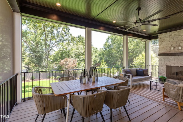 2114 Cowper Dr, Raleigh, NC 27608 - sunroom / solarium featuring a ceiling fan, an outdoor living space with a fireplace, and outdoor dining space