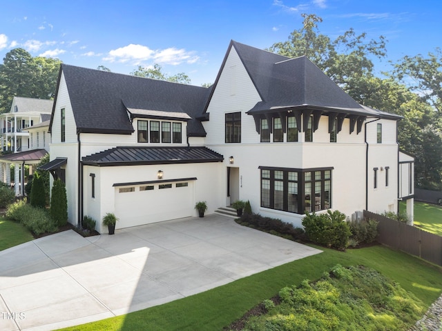 2114 Cowper Dr, Raleigh, NC 27608 - view of front facade featuring a standing seam roof, driveway, a garage, and roof with shingles