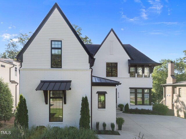 2114 Cowper Dr, Raleigh, NC 27608 - modern farmhouse style home with brick siding, a standing seam roof, and a metal roof