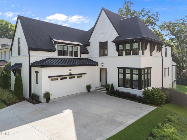 2114 Cowper Dr, Raleigh, NC 27608 - view of front of home featuring a standing seam roof, concrete driveway, an attached garage, a metal roof, and a shingled roof