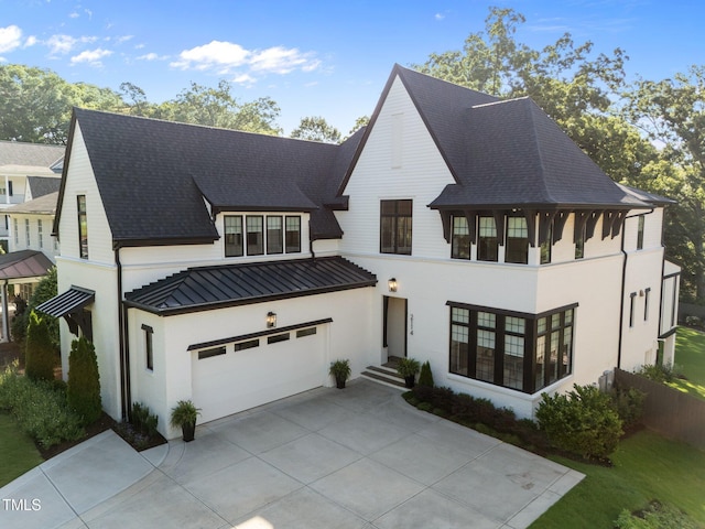 2114 Cowper Dr, Raleigh, NC 27608 - view of front of home with a standing seam roof, concrete driveway, a garage, a metal roof, and stucco siding