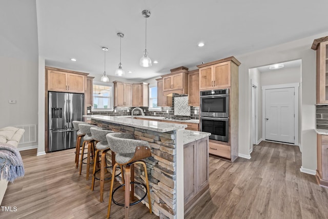 540 Pine Ridge Rd, Zebulon, NC 27597 - kitchen with stainless steel appliances, tasteful backsplash, light wood-type flooring, light stone counters, and recessed lighting