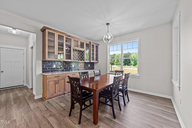 540 Pine Ridge Rd, Zebulon, NC 27597 - dining space featuring wood finished floors, baseboards, and a chandelier