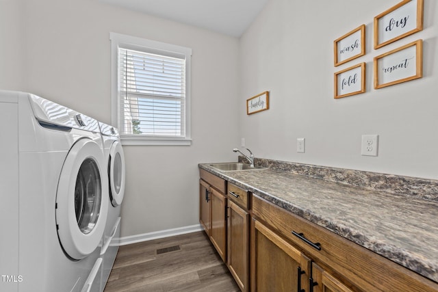 540 Pine Ridge Rd, Zebulon, NC 27597 - laundry room featuring washing machine and dryer, cabinet space, dark wood-style floors, and baseboards