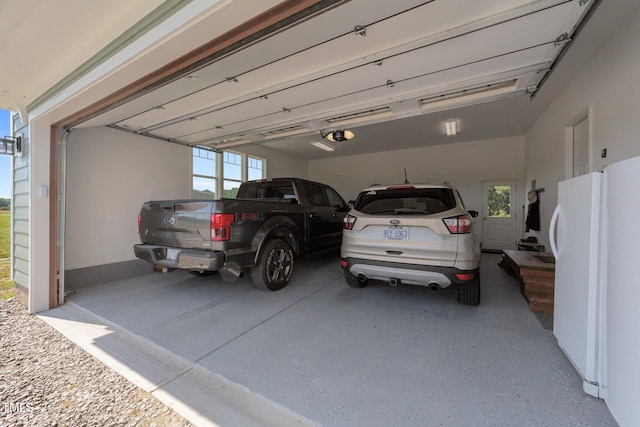 540 Pine Ridge Rd, Zebulon, NC 27597 - garage with freestanding refrigerator, a garage door opener, and driveway