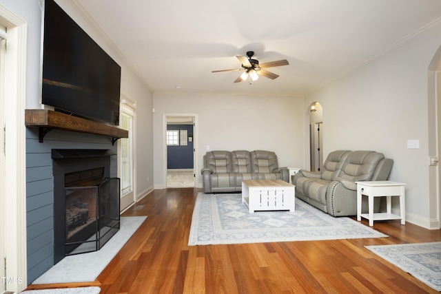 150 Churchill Rd, Louisburg, NC 27549 - living area featuring arched walkways, ceiling fan, wood finished floors, a fireplace, and baseboards