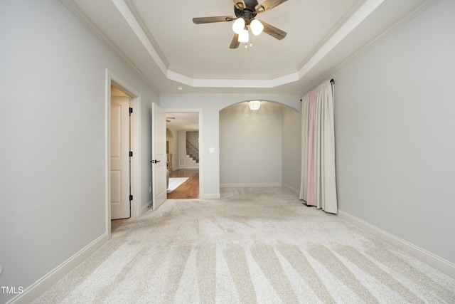 150 Churchill Rd, Louisburg, NC 27549 - carpeted spare room featuring arched walkways, a tray ceiling, ceiling fan, stairway, and ornamental molding