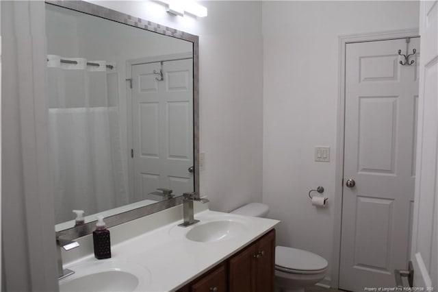 625 Marshtree Ln Unit 101, Fayetteville, NC 28314 - bathroom featuring toilet, double vanity, and a shower with shower curtain