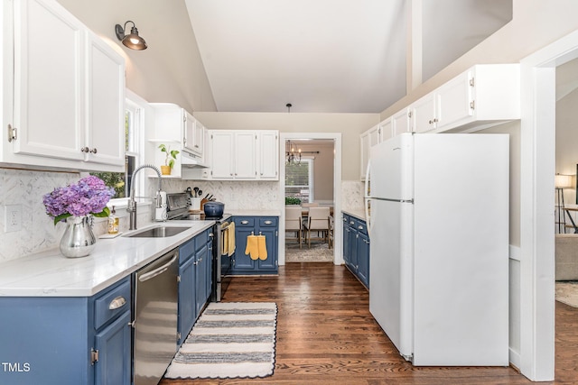 5617 Groomsbridge Ct, Raleigh, NC 27612 - kitchen with blue cabinets, appliances with stainless steel finishes, vaulted ceiling, backsplash, and dark wood finished floors