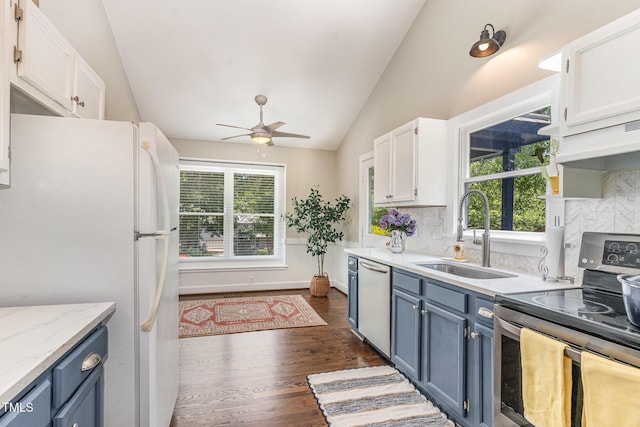 5617 Groomsbridge Ct, Raleigh, NC 27612 - kitchen featuring appliances with stainless steel finishes, a sink, lofted ceiling, blue cabinetry, and ceiling fan