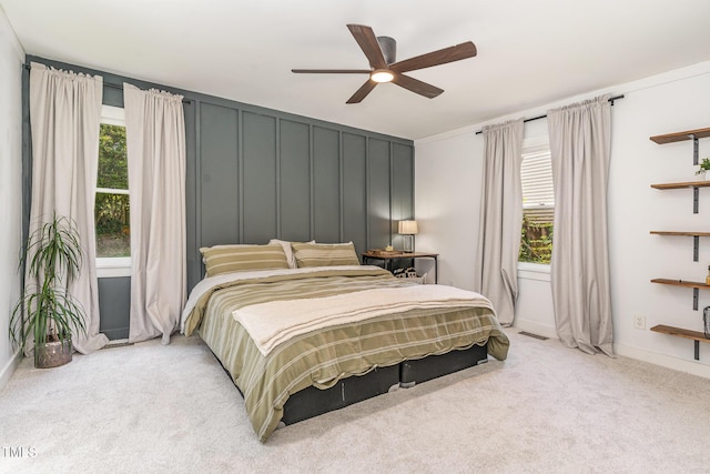 5617 Groomsbridge Ct, Raleigh, NC 27612 - bedroom with light colored carpet, multiple windows, ceiling fan, baseboards, and a decorative wall