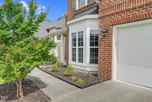 106 Elmsford St, Durham, NC 27703 - property entrance with a garage and brick siding