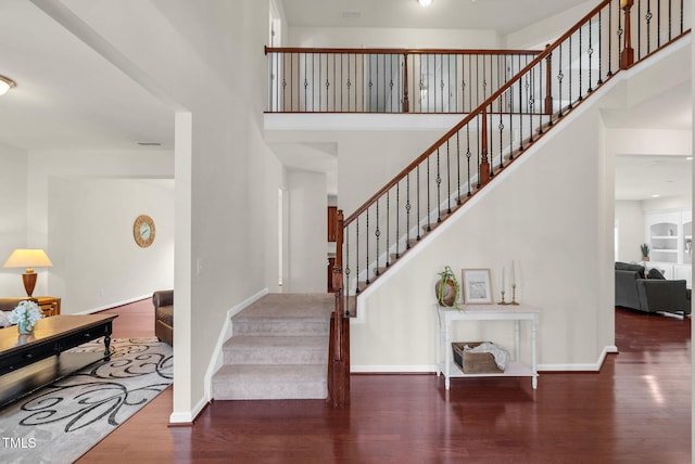 106 Elmsford St, Durham, NC 27703 - stairway with a towering ceiling, wood finished floors, and baseboards