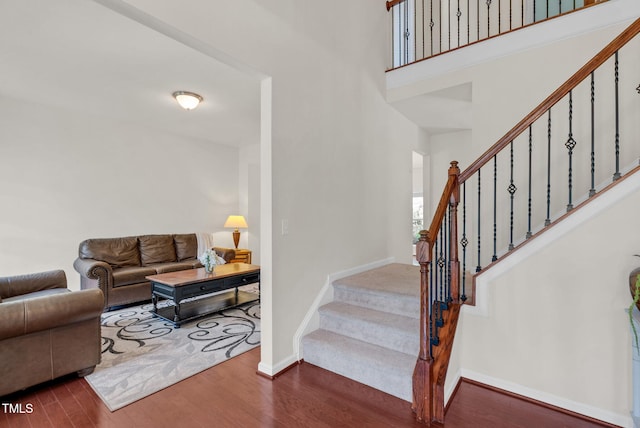 106 Elmsford St, Durham, NC 27703 - stairs with wood finished floors, baseboards, and a towering ceiling
