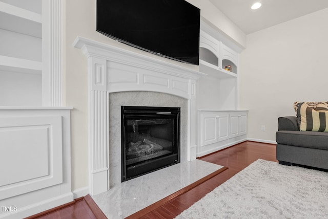 106 Elmsford St, Durham, NC 27703 - detailed view of wood finished floors, a high end fireplace, baseboards, recessed lighting, and built in shelves
