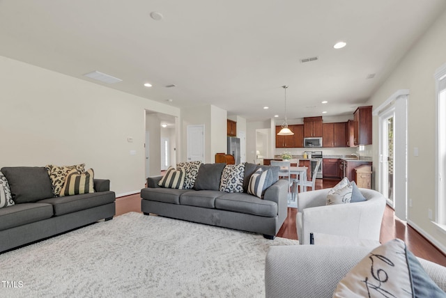 106 Elmsford St, Durham, NC 27703 - living area featuring dark wood-style floors and recessed lighting