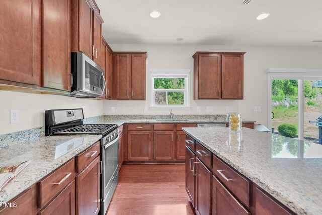 106 Elmsford St, Durham, NC 27703 - kitchen featuring stainless steel appliances, a sink, dark wood-style flooring, healthy amount of natural light, and recessed lighting