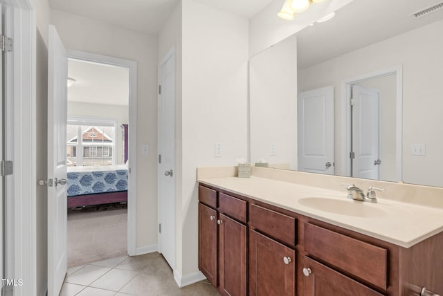 106 Elmsford St, Durham, NC 27703 - ensuite bathroom with vanity, tile patterned flooring, and baseboards