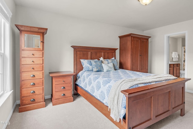 106 Elmsford St, Durham, NC 27703 - bedroom with light carpet, baseboards, and ensuite bath