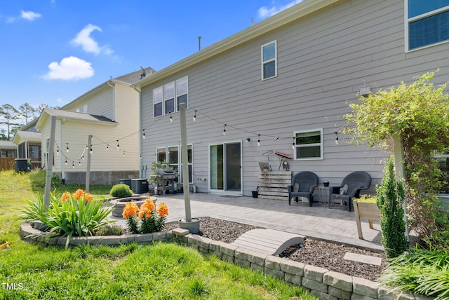 106 Elmsford St, Durham, NC 27703 - back of property featuring a patio, central AC, and a fire pit