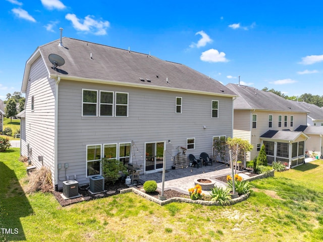 106 Elmsford St, Durham, NC 27703 - rear view of property with an outdoor fire pit, a sunroom, a patio, and central AC unit