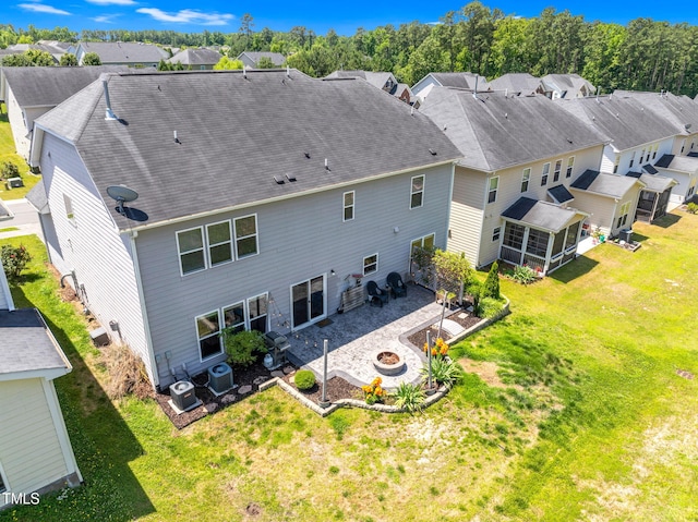 106 Elmsford St, Durham, NC 27703 - back of property featuring an outdoor fire pit, a sunroom, a patio, and a residential view