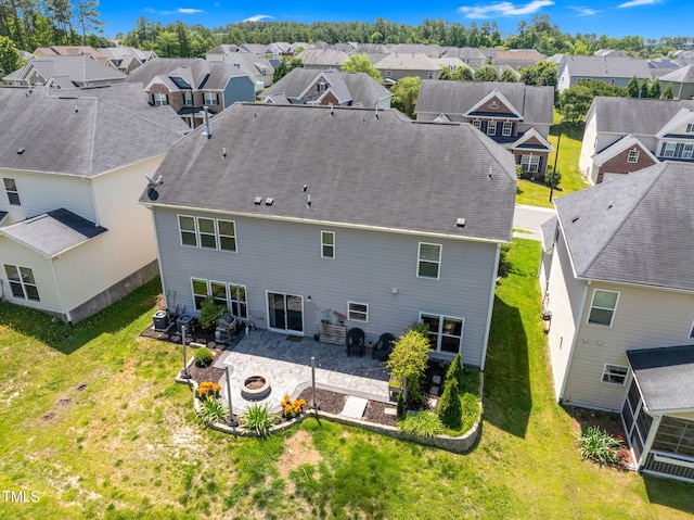 106 Elmsford St, Durham, NC 27703 - rear view of property with a residential view, a patio, a fire pit, and a lawn